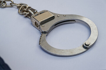 Macro view of steel handcuffs focusing on shiny chain link