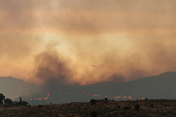 Thick Smoke Rises from a Wildfire in a Dry, Arid Landscape