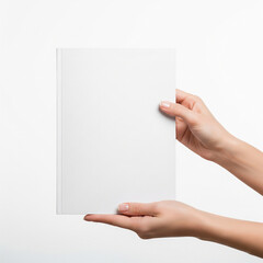 Obraz premium A clean, customizable shot of a woman's hands holding a blank brochure or book cover with copy space copy
