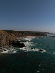 Drone view of rugged cliffs and waves along Atlantic coast, Algarve, Portugal