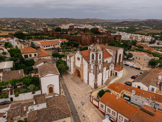 Drone view of Silves Cathedral and medieval Castle with red rooftops, Algarve, Portugal