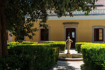Stone statue fountain in courtyard garden of historic building in Silves, Algarve, Portugal