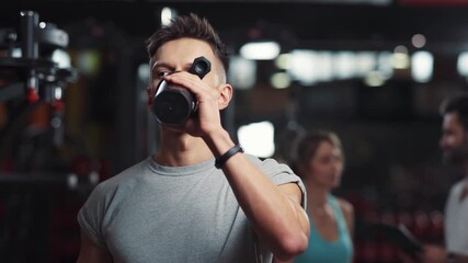 Portrait attractive man look at camera smile drinking water while resting in the gym bottle face body workout athlete exercise training sport young male bodybuilding handsome close up - Powered by Adobe