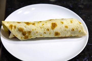 Traditional Mexican food, fajita, tortilla with meat, guacamole, black bean chili and salad