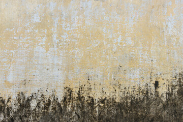 Grungy weathered concrete wall with cracks and stains, exuding a raw, aged texture background