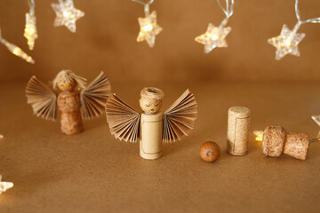 Rustic angel figurines from cork and paper with glowing star lights. Perfect for holiday greeting card design, seasonal banner graphics, or craft-focused social media content