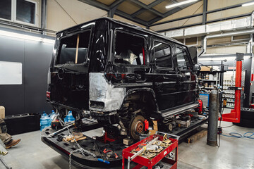 Restoration of vehicles with chain and hook. Repair in the workshop and auto. A broken car with a...