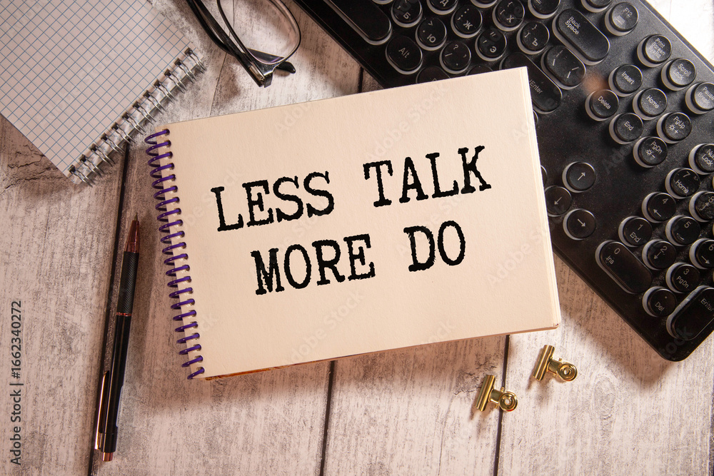 Poster text less talk more do on brown paper notepad in businessman hands on the table with diagram.