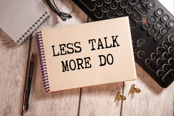 Text LESS TALK MORE DO on brown paper notepad in businessman hands on the table with diagram.