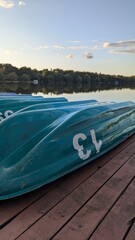 Sailor's boat near tranquil lake at sunset. Summer peaceful nature landscape.