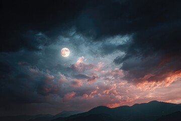 Full moon bathed in a dramatic sunset sky, obscured by stormy clouds