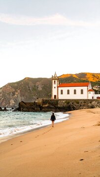 Coastal scene with woman walking on beach