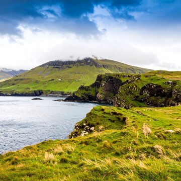 Coastal scenery, lush green hills meet the sea