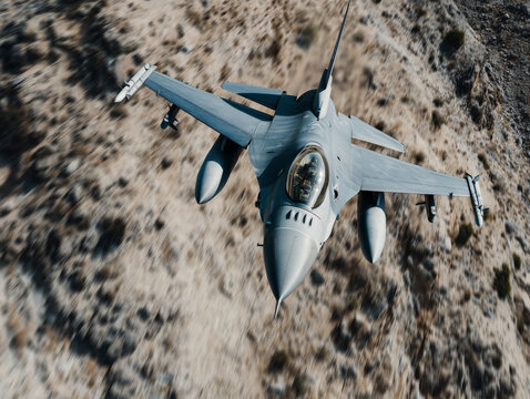 F16 Fighting Falcon flying with high altitude over the mountains