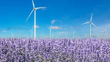 Renewable Energy or sustainable energy, wind turbine over blue sky white clouds and violet...