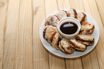 Pempek tunu. indonesian grilled fish cake served with cuko or sour and spicy dip sauce.
