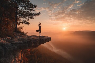 Woman practicing yoga on cliff edge at sunset