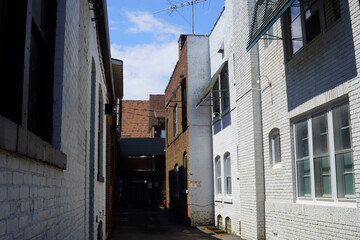 Narrow Alley Between Brick Buildings