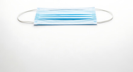 A blue surgical face mask with elastic ear loops on a white background.