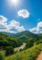 Naklejka premium Scenic valley with river and mountains under a sunny sky
