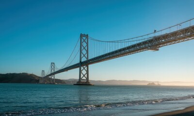 Fototapeta premium Wide shot of a modern suspension bridge spanning a tranquil bay