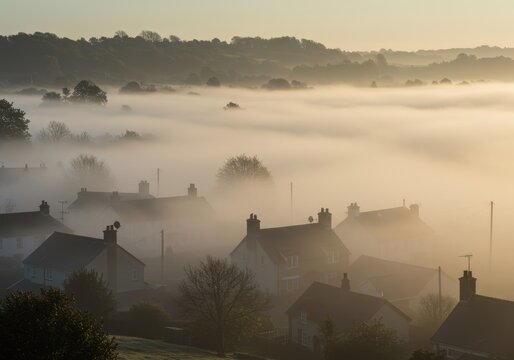 Misty village nestled in a valley at dawn - Powered by Adobe