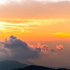 Naklejka premium Sunset over mountain clouds