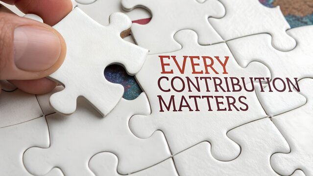 Hand Placing Puzzle Piece with Message Every Contribution Matters