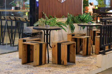 Empty table and chair in coffee shop cafe and restaurant, Empty modern cafe interior with wooden tables and warm cozy light setting.