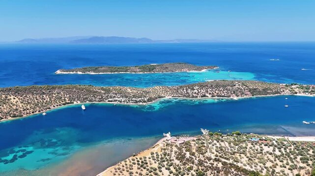4k drone video of Garip and Kalem islands with turquoise sea and coral reefs in Bademli. Dikili, a district of Izmir famous for its turquoise sea in Turkiye.