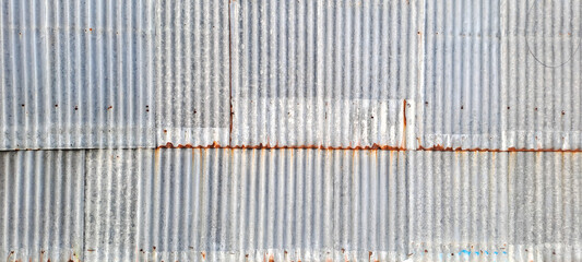 Old zinc vintage fence wall texture for background, pattern of rusty on metal panel.Tin Roof wall countryside