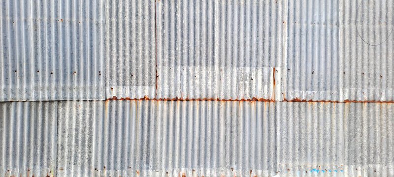 Old zinc vintage fence wall texture for background, pattern of rusty on metal panel.Tin Roof wall countryside