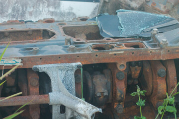 Old abandoned rusty engine with peeling paint, showing signs of wear and tear	