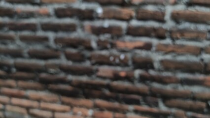Blurred photo Detailed texture of handmade terracotta bricks with natural color variations. Earthy tones and traditional craftsmanship bring warmth to any high-quality project.