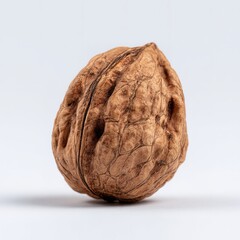 Obraz premium Striking Macro Shot of a Single Walnut Shell Against a Plain White Background.