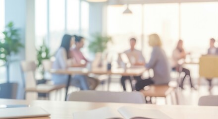 Obraz premium Out of focus office background with business people in a meeting. Modern workplace interior with natural light from large windows.