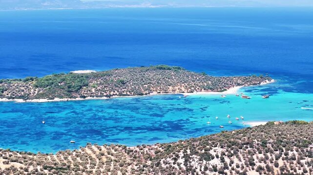 4k drone video of Garip and Kalem islands with turquoise sea and coral reefs in Bademli. Dikili, a district of Izmir famous for its turquoise sea in Turkiye.