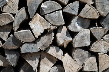 Fotobehang Brandhout Close-up of stacked firewood showing detailed wood grain texture  © kawa_xxx