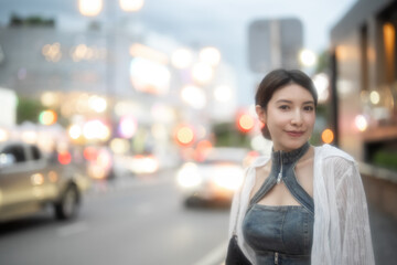 Fototapeta premium Sexy fashion woman posing in the night city with bokeh lights.
