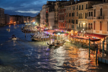 Blur Night view of grand canal with boats, gondolas, mansions along. Venice, Italy.