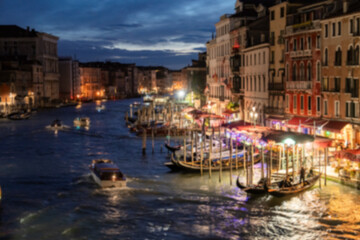 Fototapeta premium Blur Night view of grand canal with boats, gondolas, mansions along. Venice, Italy.