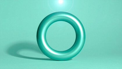 Geometric Abstract: A smooth, teal-colored torus sits serenely, casting a shadow, illuminated with a celestial glow in a studio setting. 