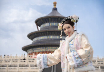 Woman wearing traditional Chinese dress in the ancient City Temple of Heaven, Beijing, China.