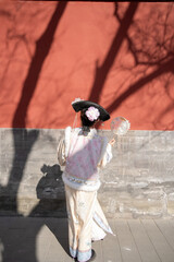 Woman wearing traditional Chinese dress in the ancient City, Beijing, China.