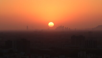 A serene sunset cityscape with golden hues, featuring distant urban silhouettes and a soft gradient sky.