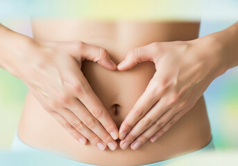 Hands forming heart shape over woman's abdomen, digestive health and wellness concept, healthy lifestyle