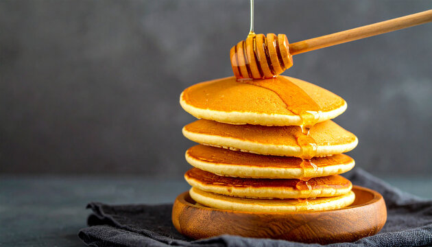 Pancakes and Honey: A stack of golden pancakes is drizzled with honey, a tempting treat that epitomizes breakfast or brunch and creating a sense of warmth and comfort.