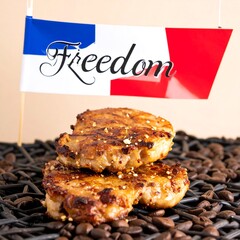 Two grilled patties, glistening with gold flakes, rest on dark coffee beans, beneath a small flag with "Freedom" inscribed