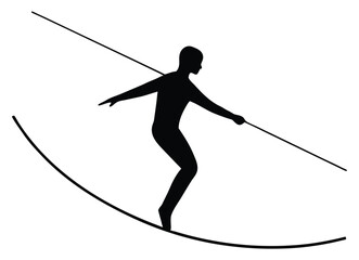 Fototapeta premium Silhouette of a tightrope walker balancing on a rope with balancing pole