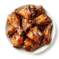 Roasted chicken drumsticks and wings in a white bowl